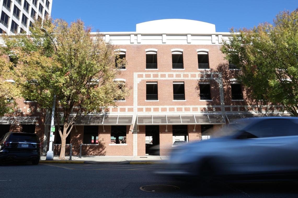 A car drives by a parking garage on Mulberry Street on Friday, Nov. 22, 2024, in Macon, Georgia. The parking garage was built in the 1970s after the demolition of The Lanier House, Macon’s premiere hotel that was built in 1850.