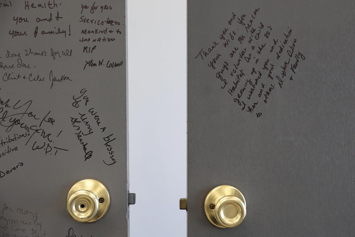 Two doors, the left one in memory of Rosalynn Carter and the right for former president Jimmy Carter, sit inside of the Carter Community Center with signatures at the Macon Area Habitat for Humanity office on Thursday, Jan. 2, 2025, in Macon, Georgia. One note left on President Carter’s door reads: “Thank you and your wife. You guys are the reason I volunteer with Habitat.”