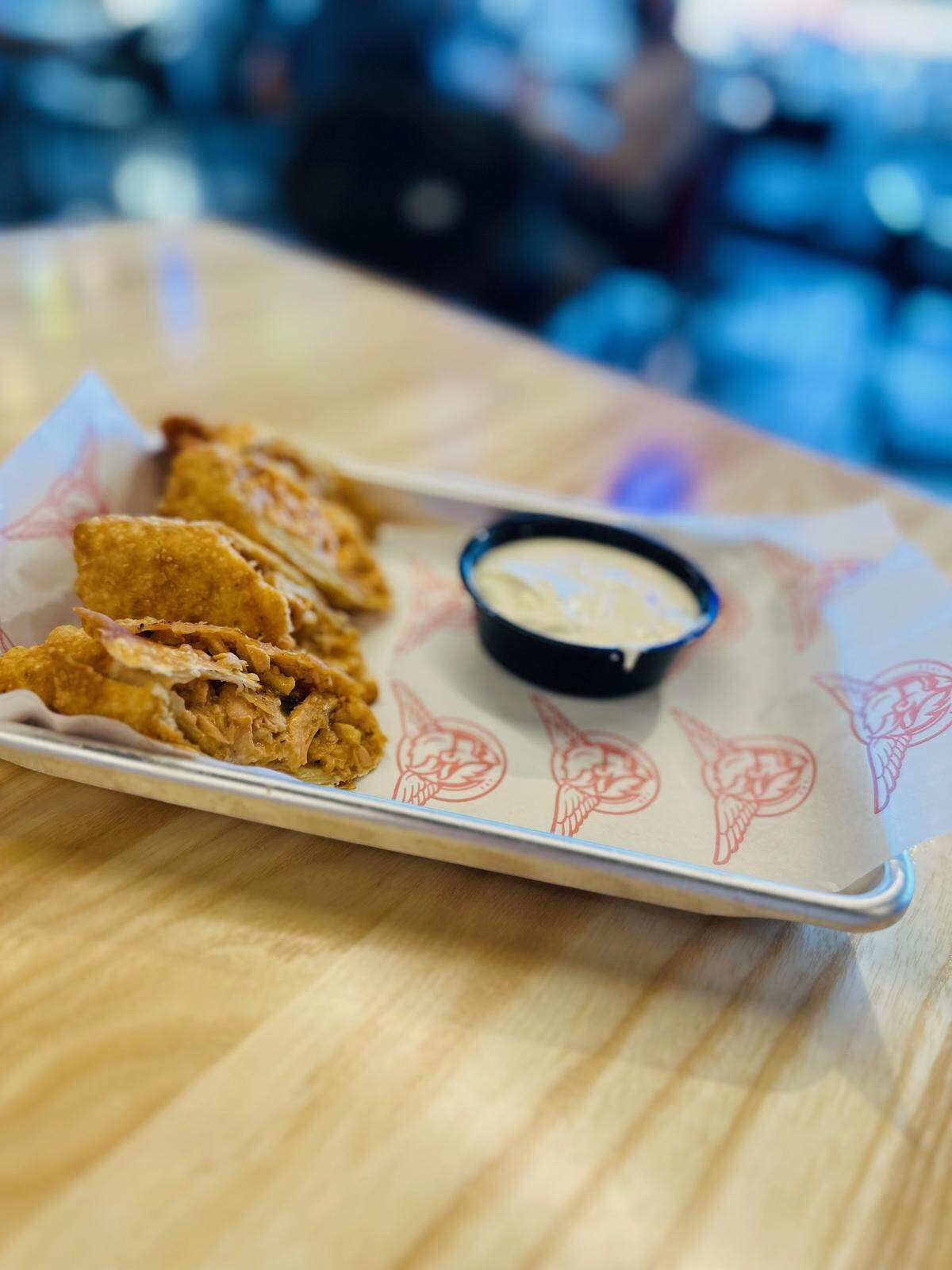 Taco Mac’s Buffalo Chicken Eggrolls are a crunchy, tangy appetizer choice.