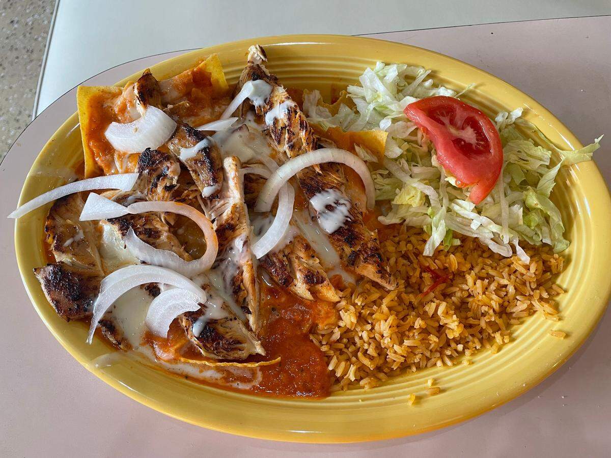Chilaquiles at the Lazy Donkey in downtown Macon includes tortillas, grilled chicken in a sauce with rice and salad.