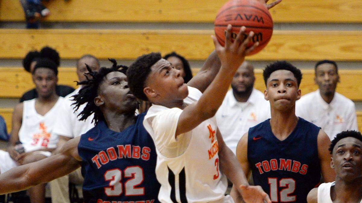 Northeast’s Travion Solomon (3) drives the lane past Toombs County’s Tyquan Toby (32). Northeast beat Toombs, 53-30.