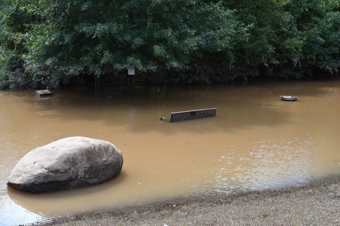 A park bench and trash can sit submerged near the boat ramp at Amerson River Park after the effects of Hurricane Helene on Monday, Sept. 30, 2024, in Macon, Georgia. The park is closed until further notice as many of its trails have flooded from the increased rainfall of Hurricane Helene last week.
