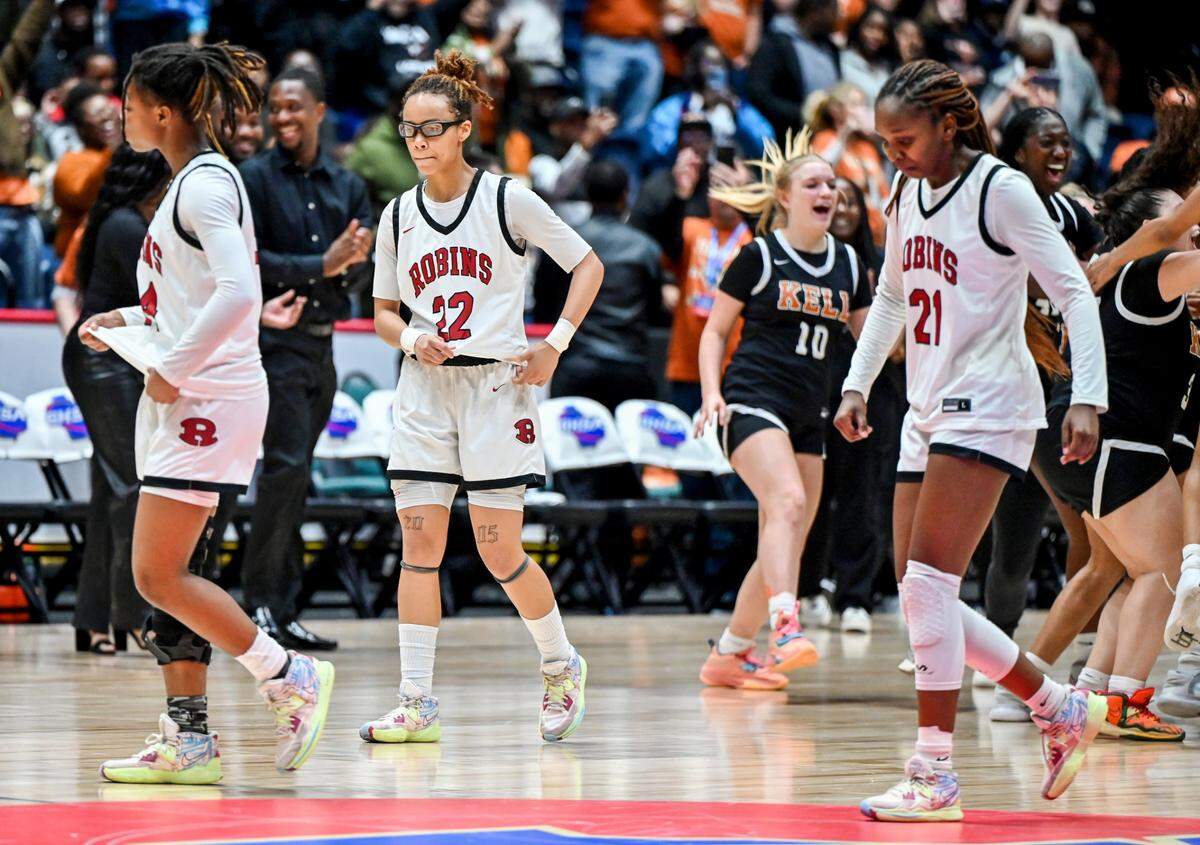 Warner Robins players walk off the court after their 57-36 loss to Kell in the GHSA 5A State Championship Thursday in Macon.