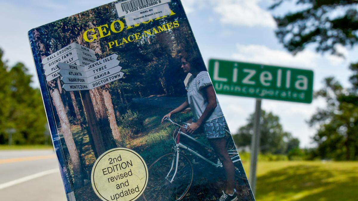 A copy of Kenneth Krakow’s “Georgia Place-Names” displayed for this photograph by the sign at the Lizella town limits. According to the book, Lizella, in western Bibb County, was named by an early postmaster, James A. Eubanks, for his two daughters, Lizzy and Ella.