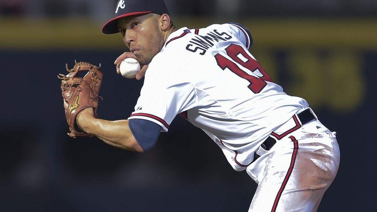 In this Sept. 30, 2015, file photo, Atlanta Braves shortstop Andrelton Simmons throws to first base for an out on Washington Nationals' Wilson Ramos during a baseball game in Atlanta. The Braves have traded Simmons to the Los Angeles Angels in a deal for shortstop Erick Aybar and pitching prospects Sean Newcomb and Chris Ellis, in a deal announced Thursday, Nov. 12.