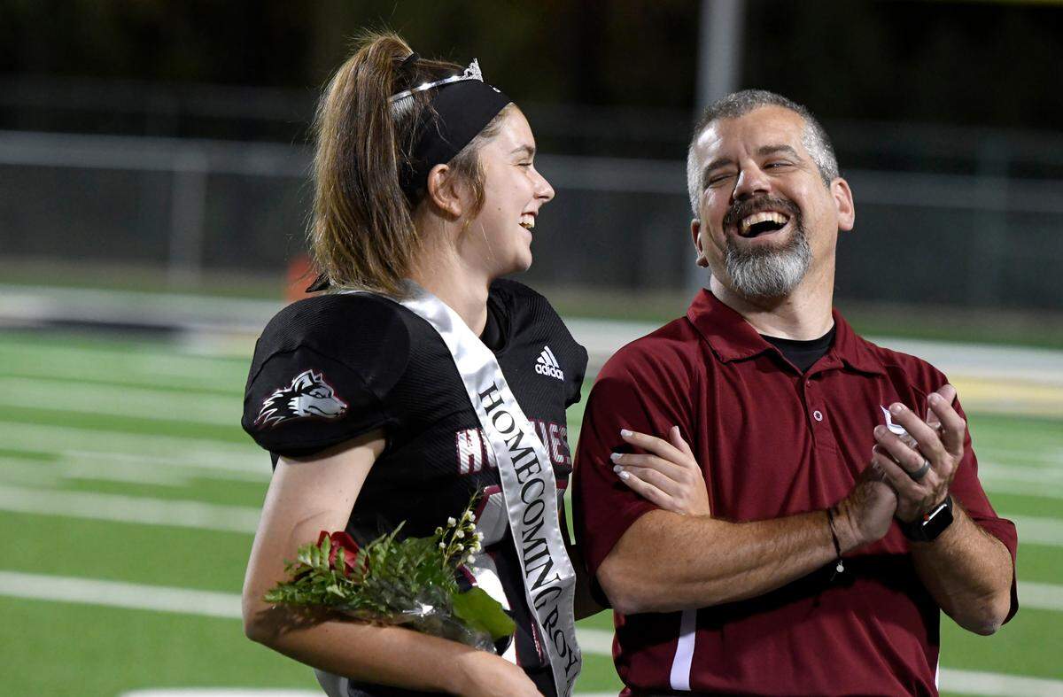 Howard place kicker Elizabeth Rodenroth and her dad Donn react after Elizabeth was announced as homecoming queen at halftime of the Huskies’ game against Jackson Friday night.