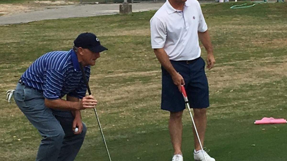 Lee Gerdes, left, and Coleman Tidwell line up a putt during Saturday's round at the Cherry Blossom Tournament. 
 John Kosater