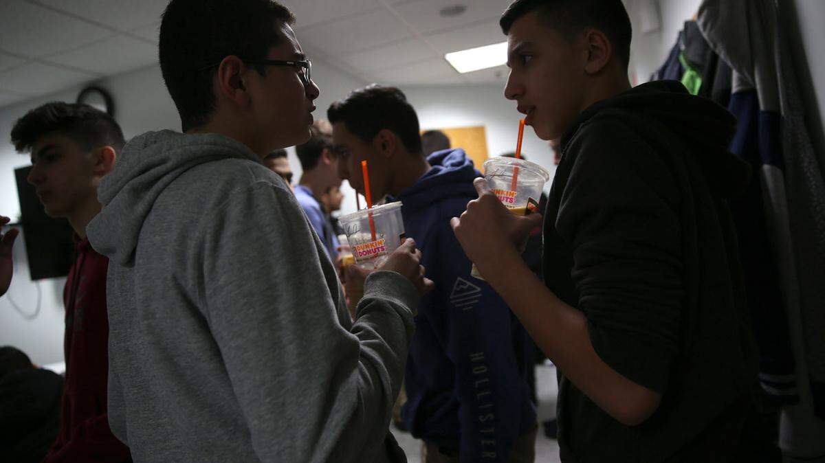 ABEL URIBE/CHICAGO TRIBUNEBoys eat snacks and enjoy drinks while chatting in a separate room from the girls during a break at the Friday Night Lives gathering.