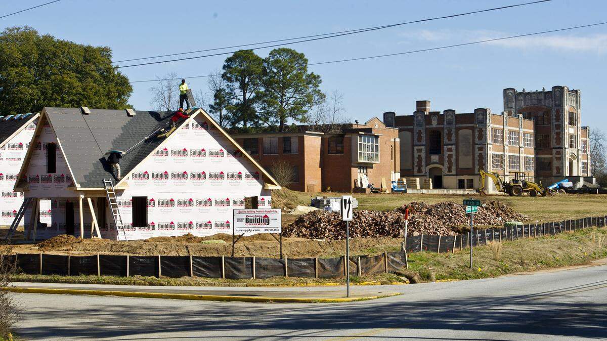 A roofing crew puts shingles on the house under construction on the corner at A.L. Miller School on Montpelier Avenue in January.