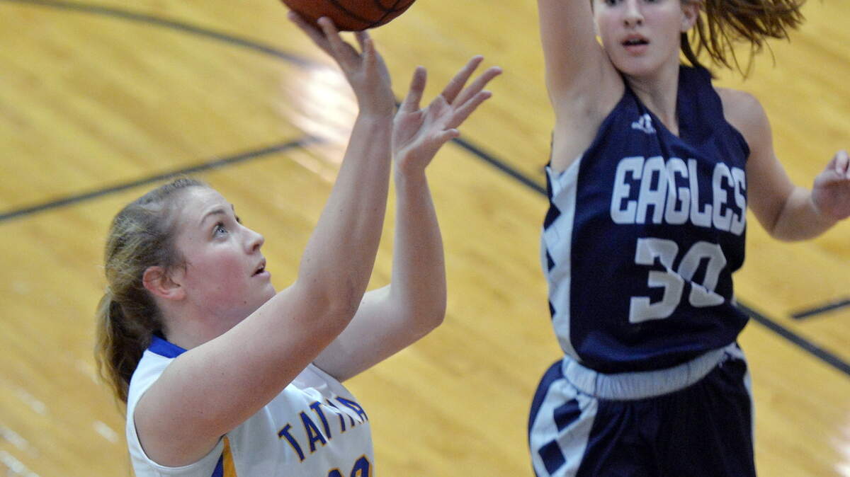 Allie Gordon (32) drives the lane for a Tattnall Square basket against Stratford's Emory Sutherland (32).
