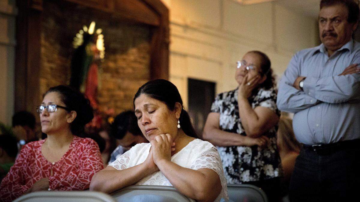 DAVID GOLDMAN/THE ASSOCIATED PRESSA parishioner prays during Mass at St. John Paul II Pastoral Center in Gainesville.