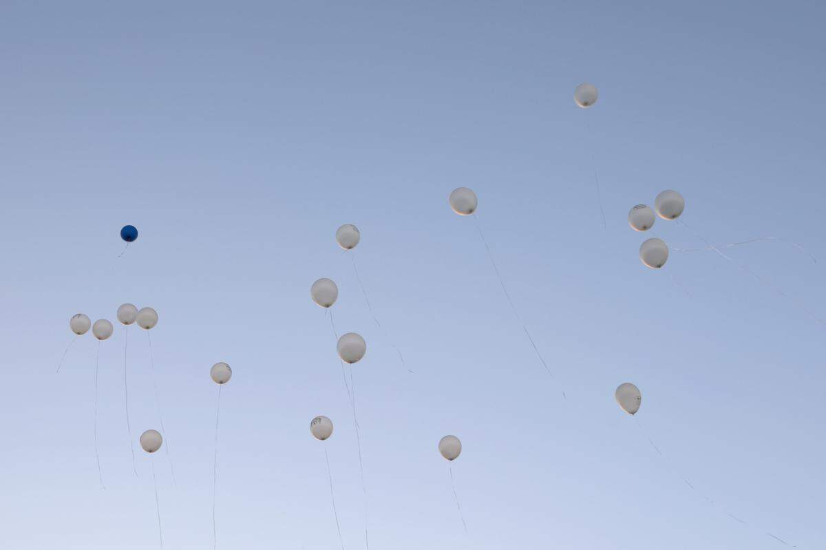 Vigil attendees release balloons into the air on Tuesday, Oct. 22, 2024, outside of the Bibb County Jail in Macon, Georgia to honor inmate Stephen Fossett who died in the Bibb County Jail in May. Family, community members and lawyers used the vigil to call for change and to release the body cam footage from the jail. Fossett’s death was ruled a homicide earlier this month.