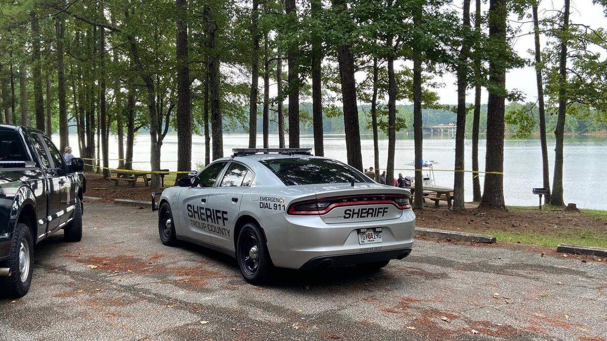 The discovery of two dead men in a Georgia lake has led to the arrest of woman on two counts of “malice murder,” according to the Troup County Sheriff’s Office.
