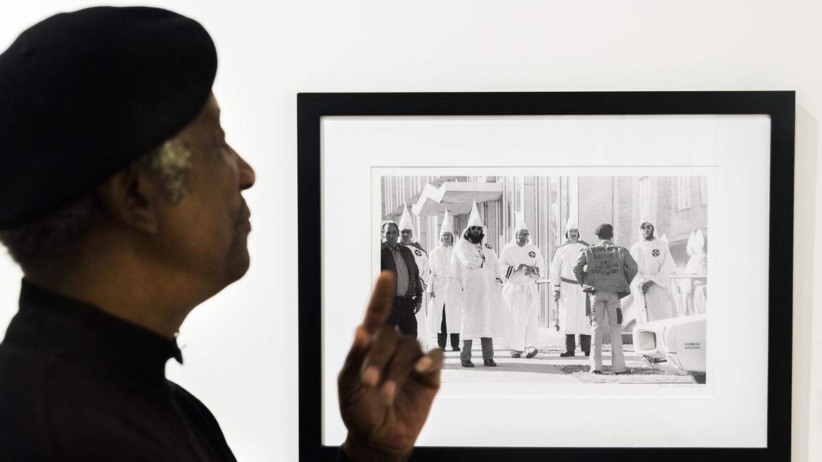 Jim Alexander with an image of an Ku Klux Klan protester facing down Klan members during a rally in Tupelo, Miss. in 1978. This image and others were used to prosecute Klan members who assaulted protesters.