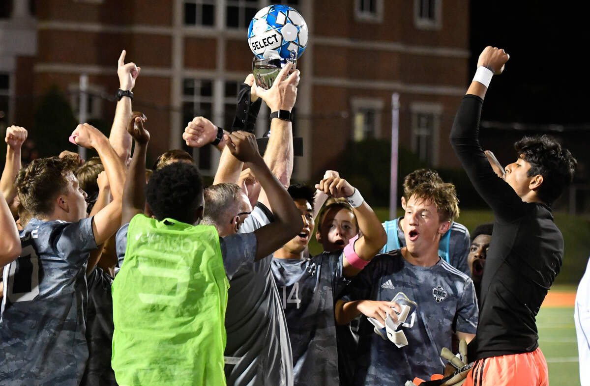 GMC players hoist the trophy after the BulldogsÕ GHSA 1A State Championship win over ACE Friday night at Mercer.
