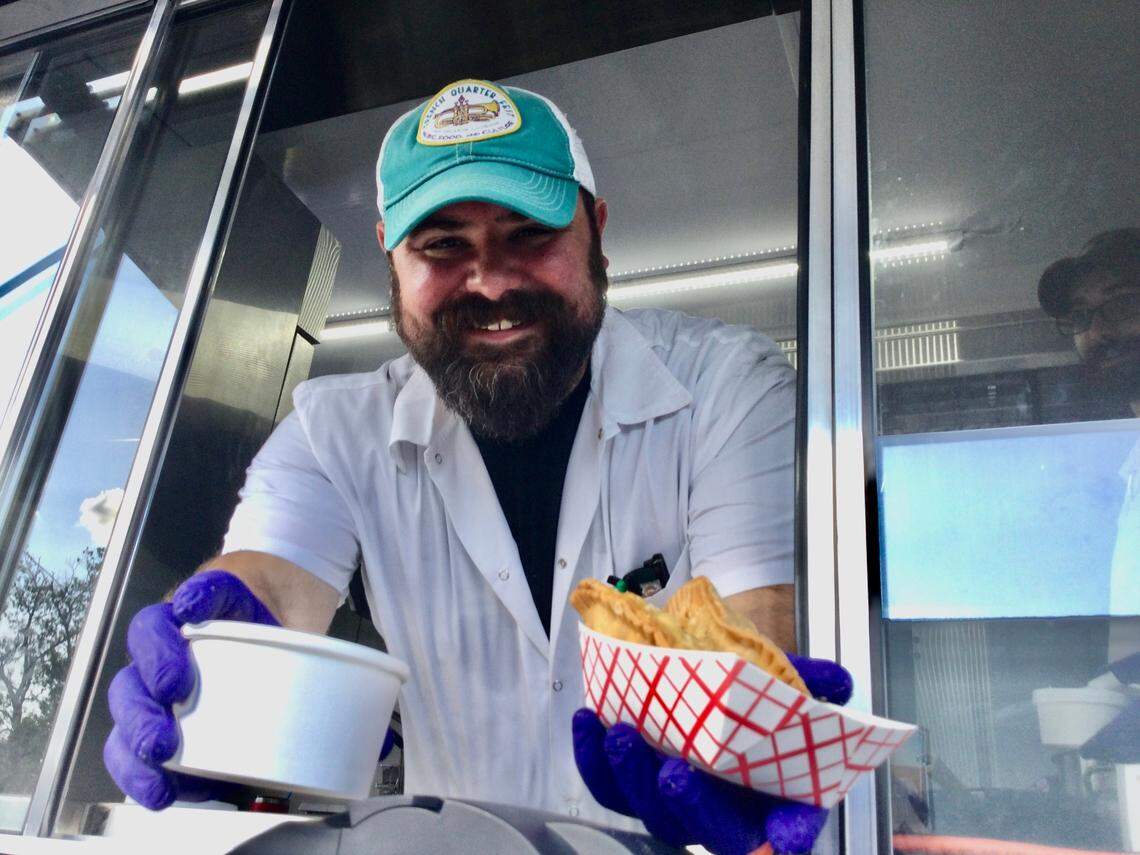 John Staurulakis serves up some chicken and andouille gumbo and a roast beef hand pie and chicken pot hand pie from the ‘Orleans on Wheels food truck at a Food Truck Friday in Perry. Staurulakis is the general manager and executive chief for ‘Orleans on Carroll Street, a new restaurant coming to 807 Carroll St. in downtown Perry.