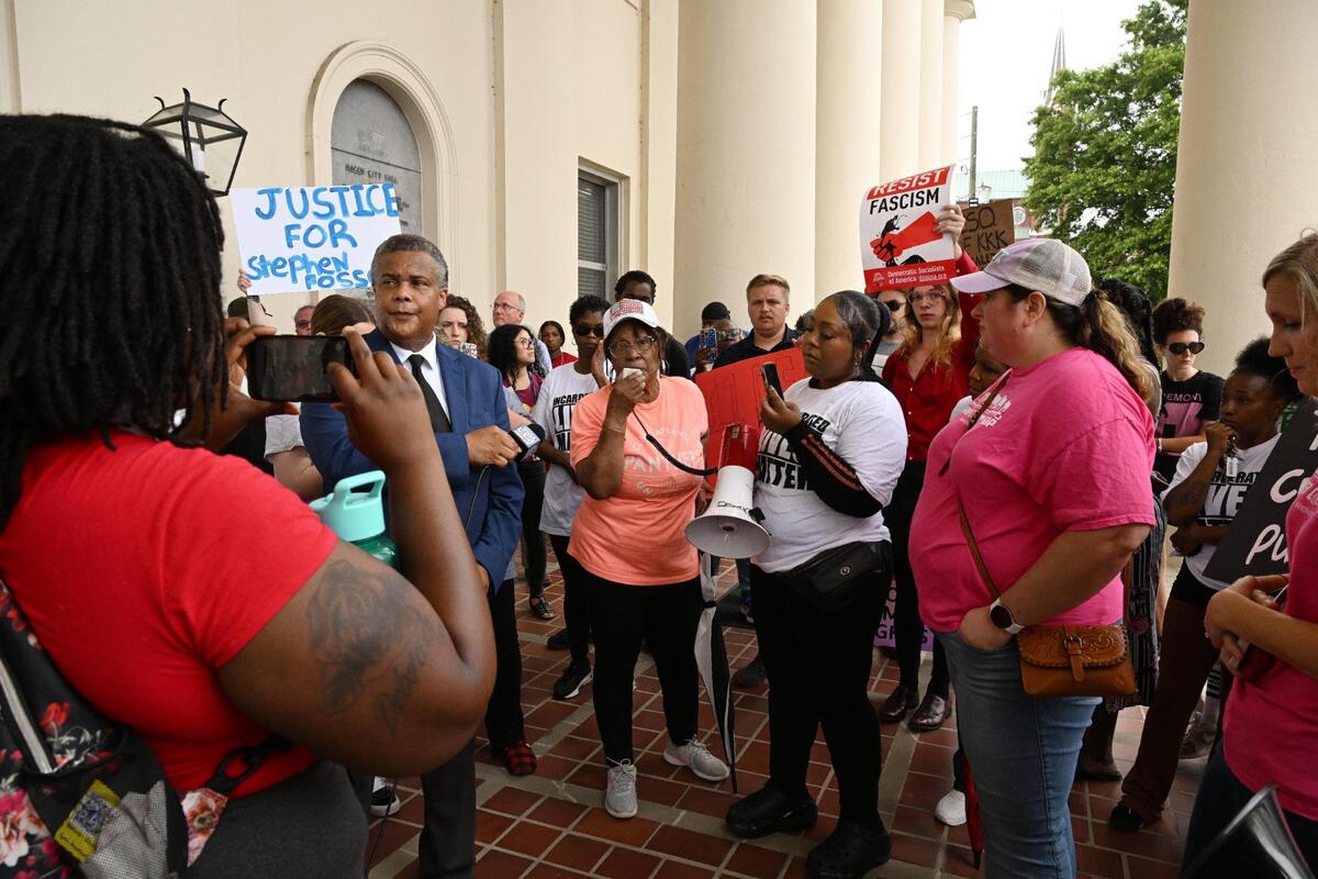 Protest attendee Carrie Bronson (middle) speaks outside of Macon City Hall on Wednesday, May 28, 2025, in Macon, Georgia. Dozens of protesters first gathered in front of the Bibb County Jail and then walked to Macon City Hall attempting to talk to Mayor Lester Miller.