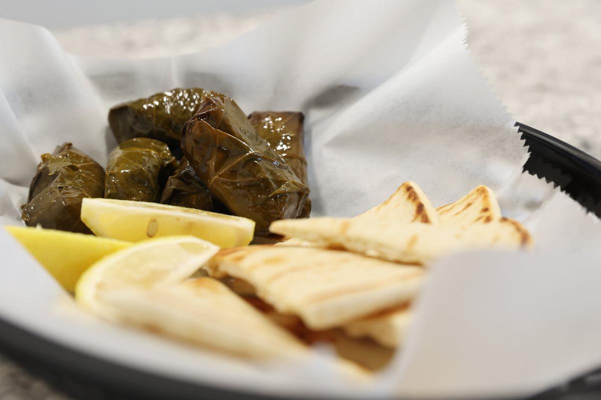 Dolamades, or grape leaves stuffed with rice, sit on a plate with pita on the counter of Greek Corner Deli on Wednesday, Sept. 4, 2024, in Macon, Georgia. Greek Corner Deli reopened in June and is now located on Spring Street after closing its downtown location in 2018.