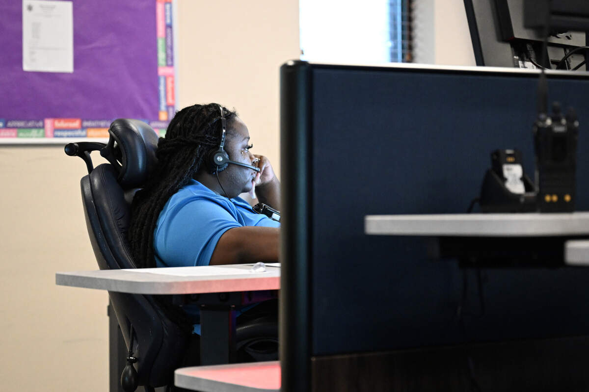 A 911 dispatcher responds to a call on Wednesday, May 7, 2025, at the Macon-Bibb County 911 Communications Center in Macon, Georgia. Dispatchers rank calls based on severity, which prompts how quickly deputies should respond.