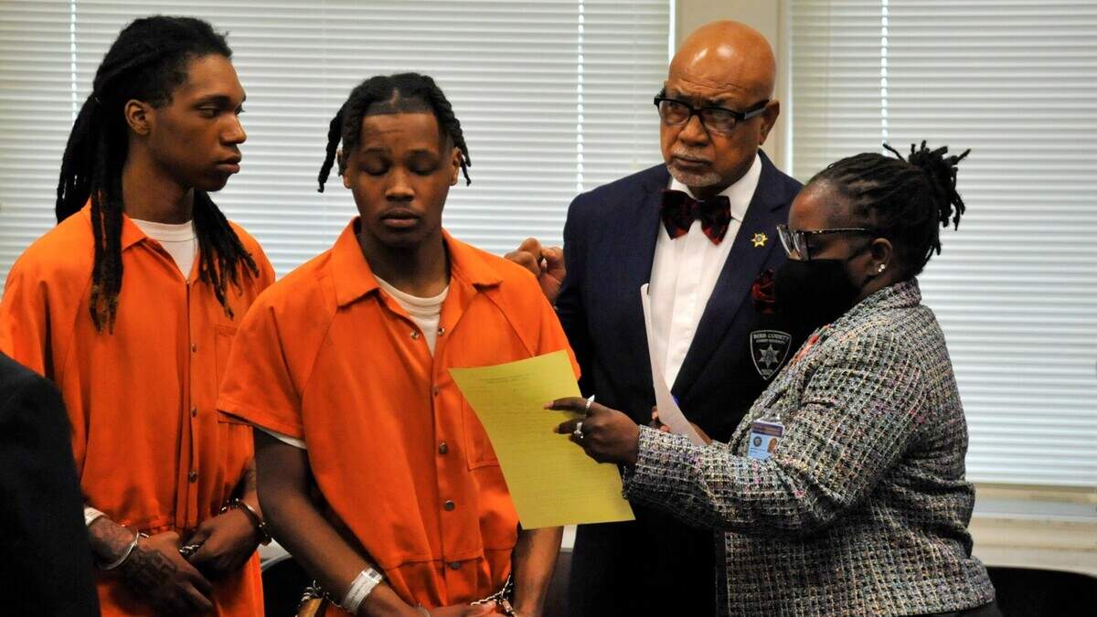 Laquerro Harris Jr., left, and Ty’Reek Young, both in orange jailhouse jumpsuits, at a hearing in Bibb County Superior Court on Monday, May, 2, 2022, where they pleaded guilty to separate armed holdups in 2019.