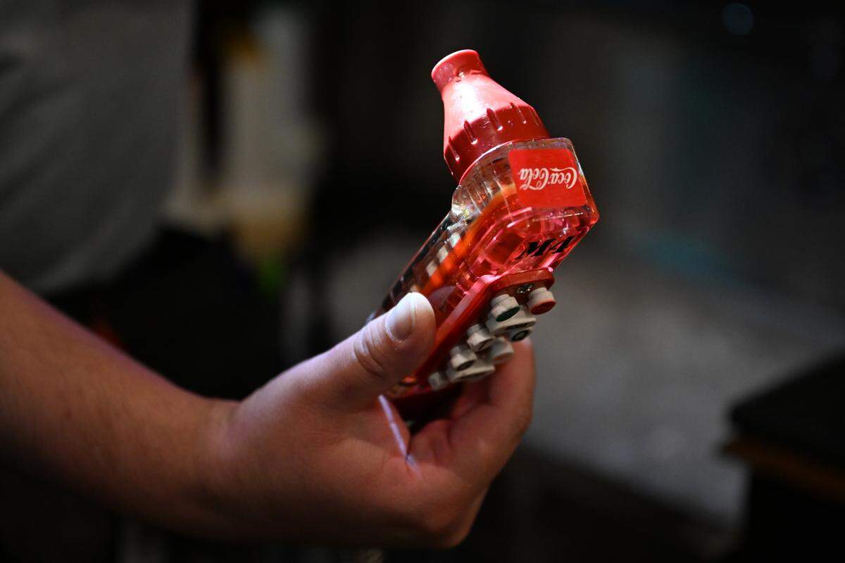 North Central Health District environmental health specialist Mark Torres-Hauck shines his flashlight into a soda gun during a mock inspection at Parish on Cherry on Thursday, Sept. 18, 2025, in Macon, Georgia. A restaurant’s health inspection typically takes place every six months. 