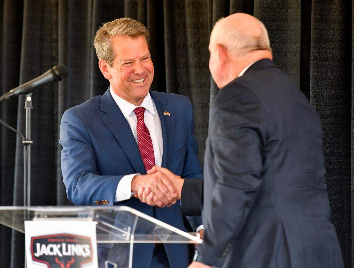 Gov. Brian Kemp shakes hands with Sonny Perdue, chancellor of the University System of Georgia, at the announcement about Jack Link’s to create 800 jobs with the construction of a manufacturing facility in Perry.