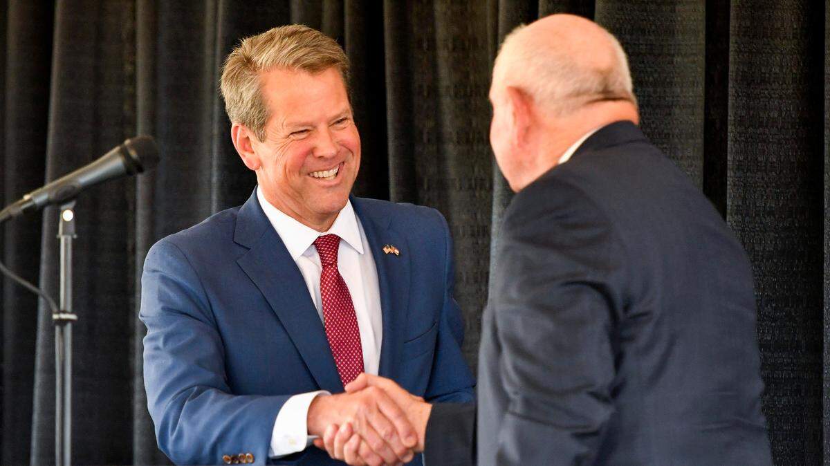 Gov. Brian Kemp shakes hands with Sonny Perdue, chancellor of the University System of Georgia, at the announcement about Jack Link’s to create 800 jobs with the construction of a manufacturing facility in Perry.