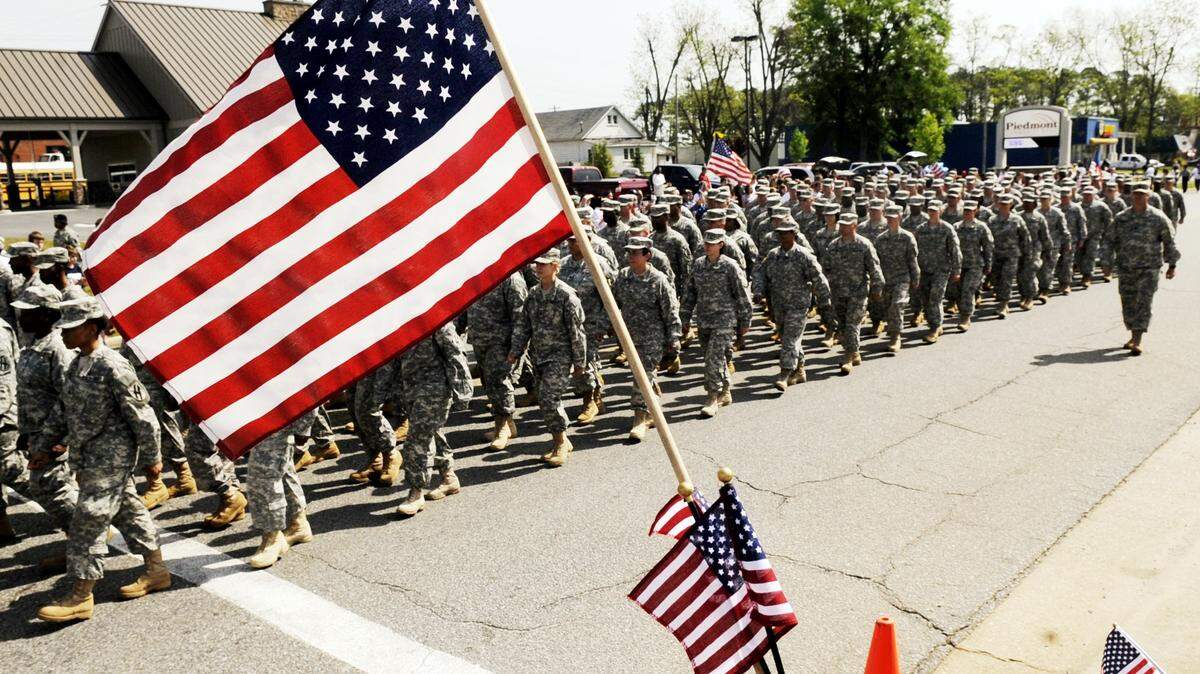 Members of the Georgia National Guard’s 48th Brigade march up East Johnston Street during a parade in Forsyth in 2009 prior to a deployment to Afghanistan. In October, about 2,000 members of the unit will begin training for a return deployment to the war-torn nation.