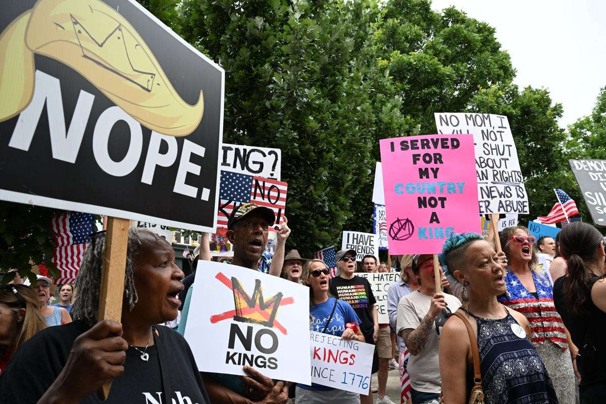Vinnie Dupree (far left) and her husband Alvin Dupree (left), from Twiggs County, Georgia, chant alongside other protesters during a No Kings protest on Saturday, June 14, 2025, in downtown Macon, Georgia. The couple criticized the Trump administration’s actions, including the decline of the Dublin VA, whose services they said have worsened since Trump took office.
