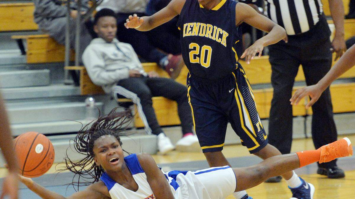 Central's Tyleia Williams (21) saves a ball she nearly had stolen at midcourt by Kendrick's Destiny Murph (20) during Tuesday's game.
