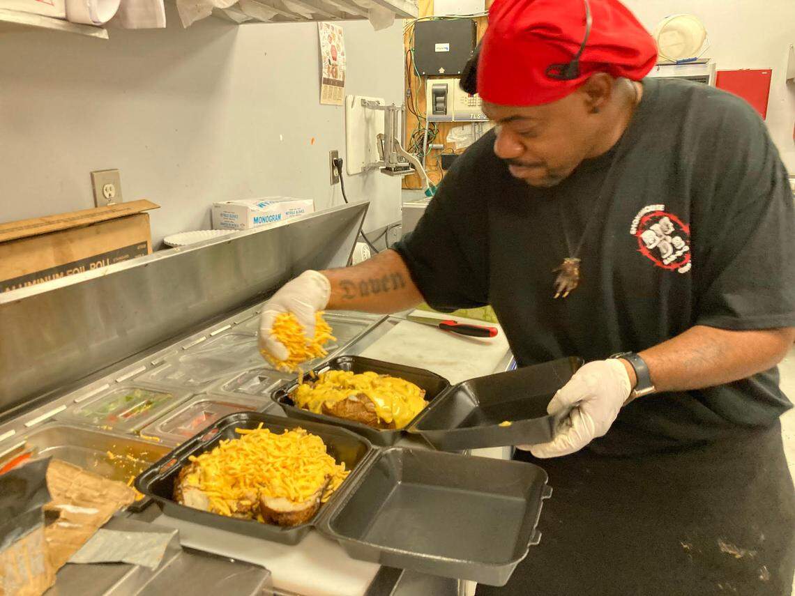 Orelle Hill adds cheese to loaded potatoes at Big D’s Bar-B-Q at 280 Carl Vinson Parkway in Warner Robins.