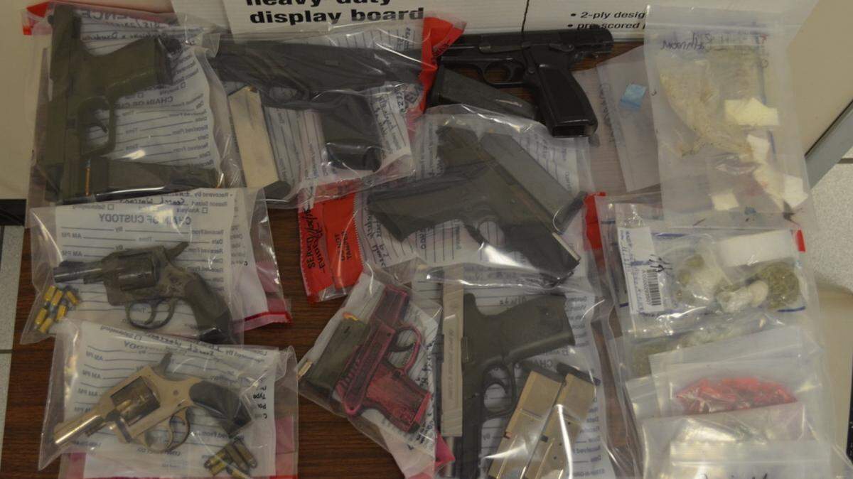 A SWAT team raid early Sunday at 619 Poppy Avenue netted eight guns and several bags of powder cocaine and marijuana, according to the Bibb County Sheriff's Office.