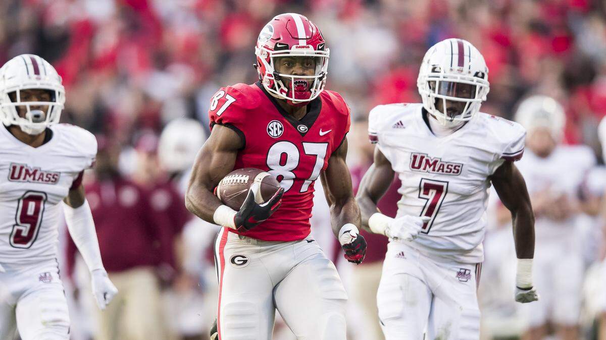 Tyler Simmons runs from University of Massachusetts Minutemen on November 17, 2018. UGA won the game over UMass 66-27.