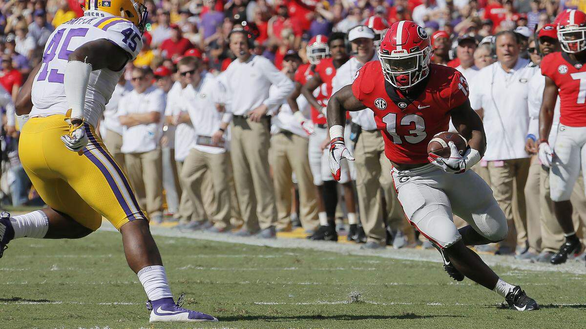 Georgia Bulldogs running back Elijah Holyfield (13) gets nine yards on a run. The University of Georgia Bulldogs played the Louisiana State University Tigers in a NCAA college football game Saturday at Tiger Stadium in Baton Rouge, Louisiana.
