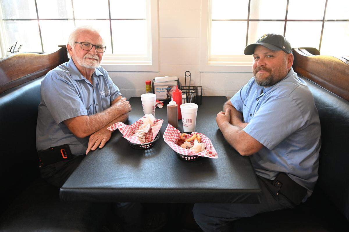 Terry Mock, left, and friend and co-worker Eric Hester, who work for the Houston County Water Department, are fans of Fincher’s Barbecue and followed the restaurant to its new Warner Robins location. The new spot replaces the Davis Drive location.