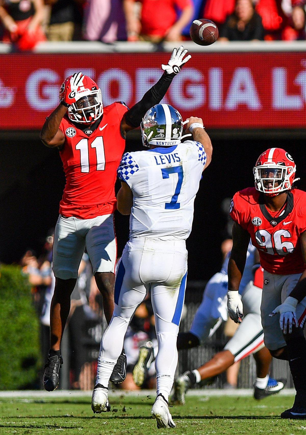 DONN RODENROTH,Athens, Georgia, 10/16/2021: Georgia defensive back Derion Kendrick pressures Kentucky quaterback Will Levis in action Saturday in Athens.
