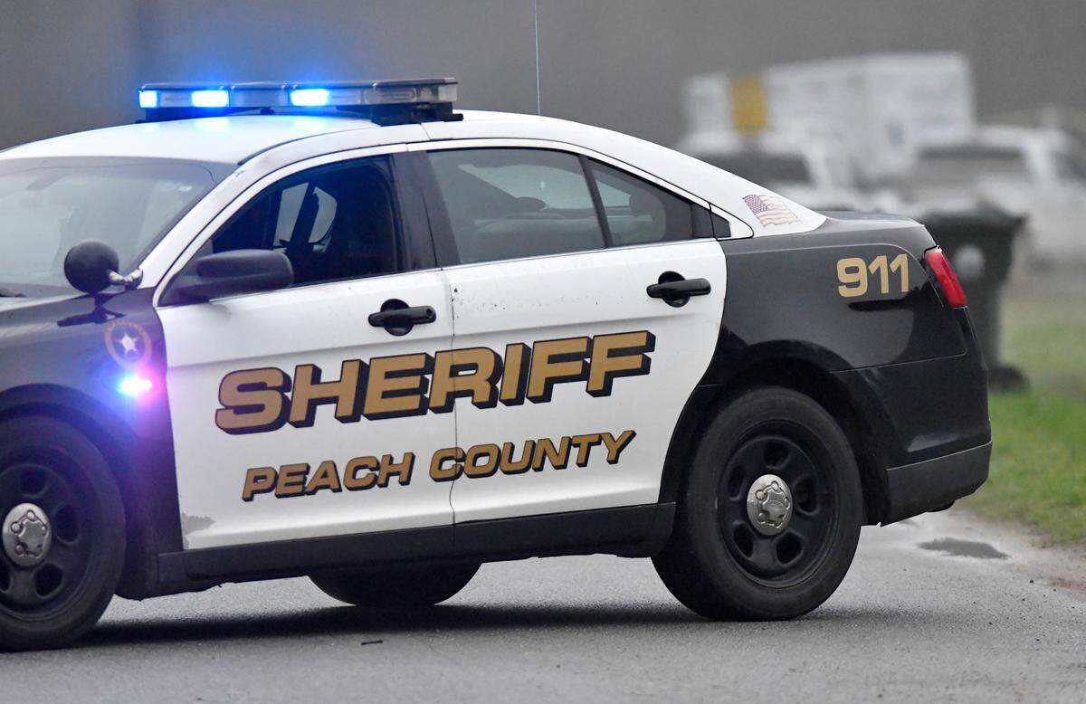 A Peach County sheriff’s car blocks a section of Greer Road in Crawford County Feb. 18, 2020, where the body believed to be that of a missing Fort Valley State University student, Anitra Gunn, was found.
