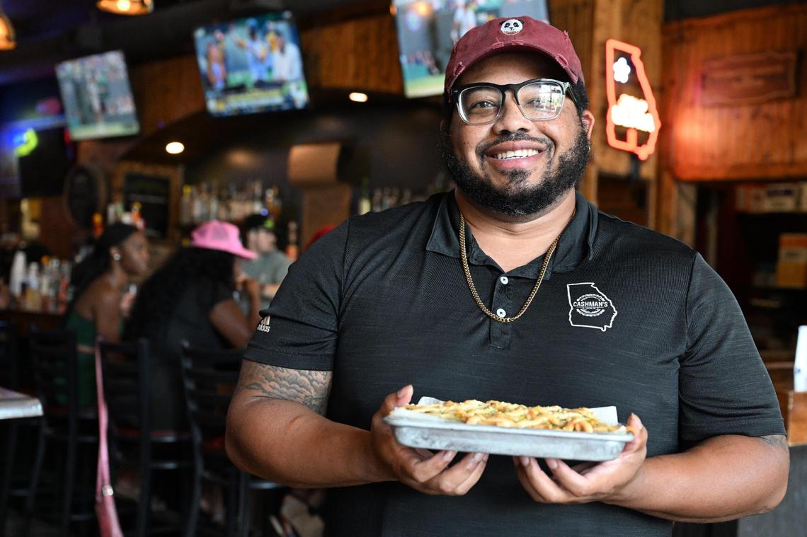 Cashman’s Pub executive chef Richard Perkins poses with his 2025 Downtown Macon French Fry Fight submission Chicken Pot Fry inside of Cashman’s Pub on Thursday, July 3, 2025, in Macon, Georgia. Cashman’s Pub won two times in Macon Fry Fight’s three year run, with hopes for another win in next week’s competition.