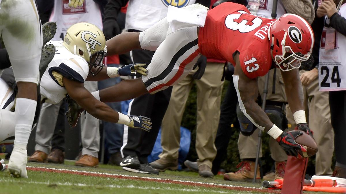 Georgia running back Elijah Holyfield (13) dives for the pylon for a second quarter touchdown during the Bulldogs 45-21 win over Georgia Tech.