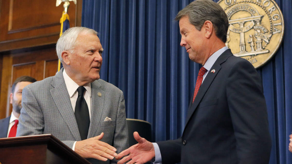 Republican Brian Kemp, right, shakes hands with Georgia Gov. Nathan Deal at the Capitol on Nov. in Atlanta.