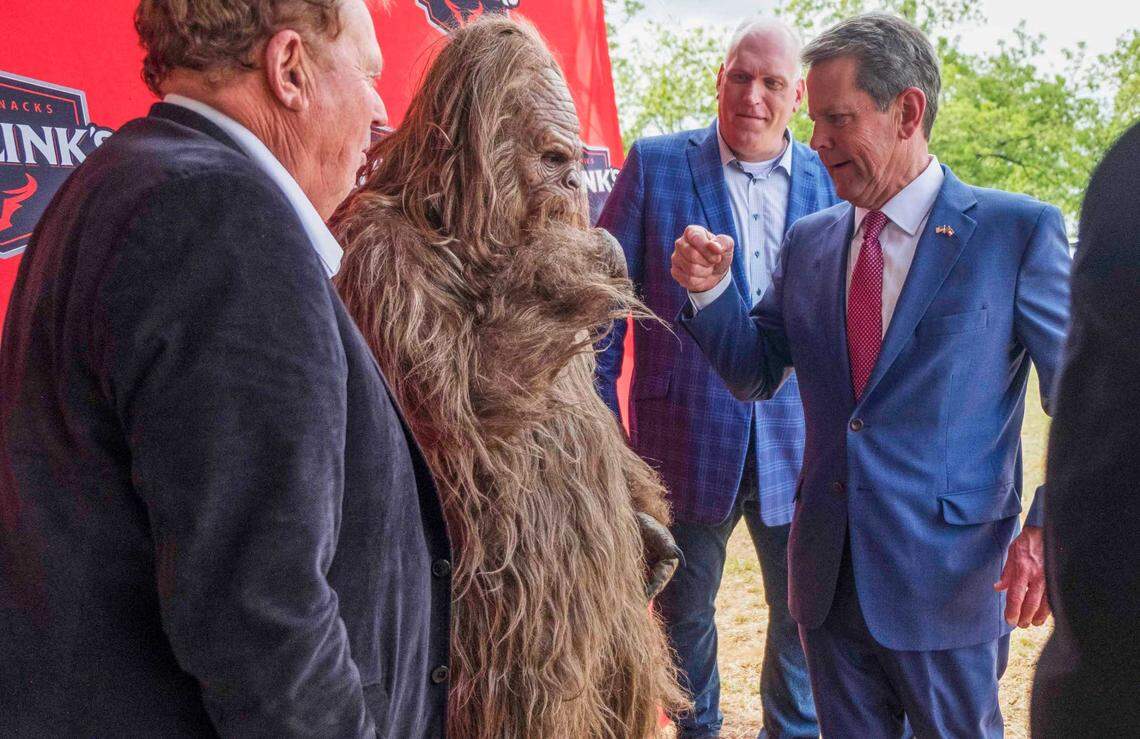 Gov. Brain Kemp gives a fist bump to Jack Link’s Protein Snacks mascot Sasquatch as he arrives in Perry Tuesday afternoon to help announce the development of a new $450 million Jack Link’s meat snacks facility.