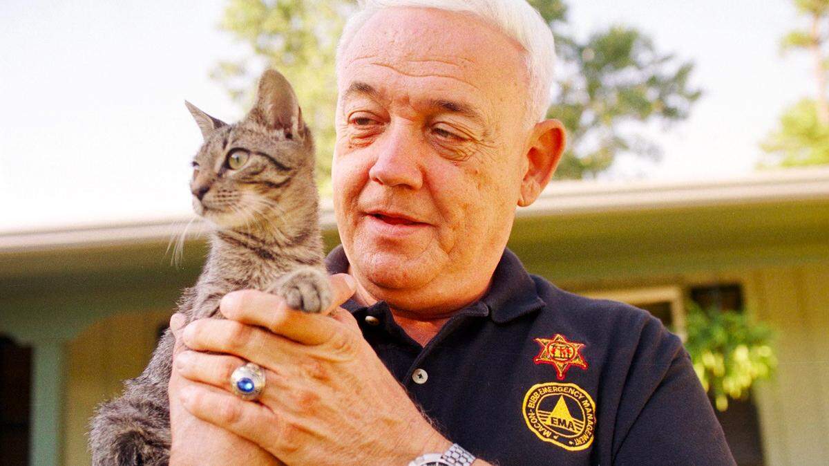 Former Bibb County EMA Director Johnny Wingers in 1999 holding his newly acquired cat “Floyd,” named for the hurricane the cat was abandoned in during coastal evacuations when many evacuees were sent to Macon.