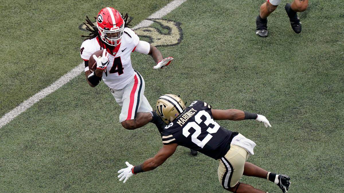 Vanderbilt cornerback Jaylen Mahoney (23) closes in on Georgia running back James Cook (4) in the first half of an NCAA college football game Saturday, Sept. 25, 2021, in Nashville, Tenn. (AP Photo/Mark Humphrey)