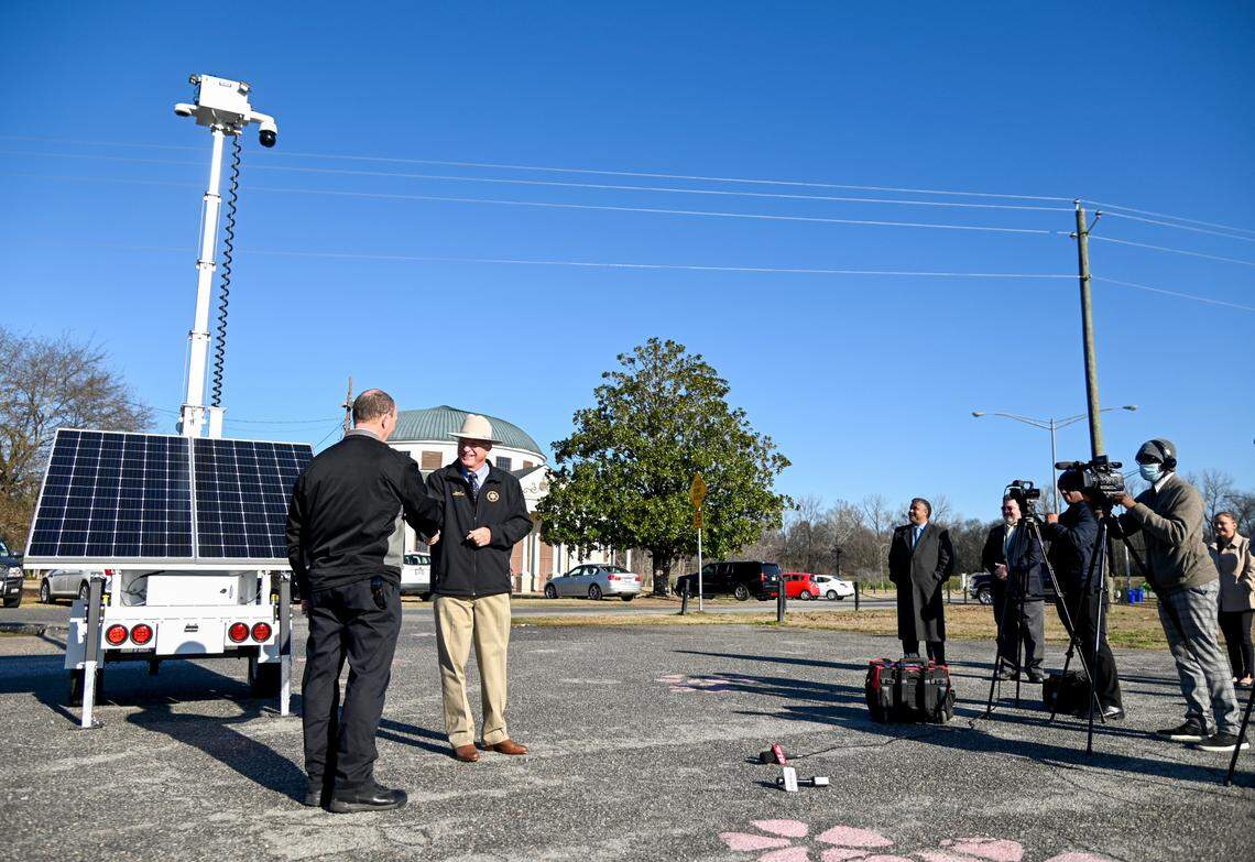 Bibb County Sheriff David Davis shakes hands with Warren Selby with the Macon Bibb Law Enforcement Foundation after the Foundation announced the purchase of a solar-powered, $26,000 portable camera. The camera which can be raised to 25 feet will be used by the Sheriff’s office to help monitor crowded events.