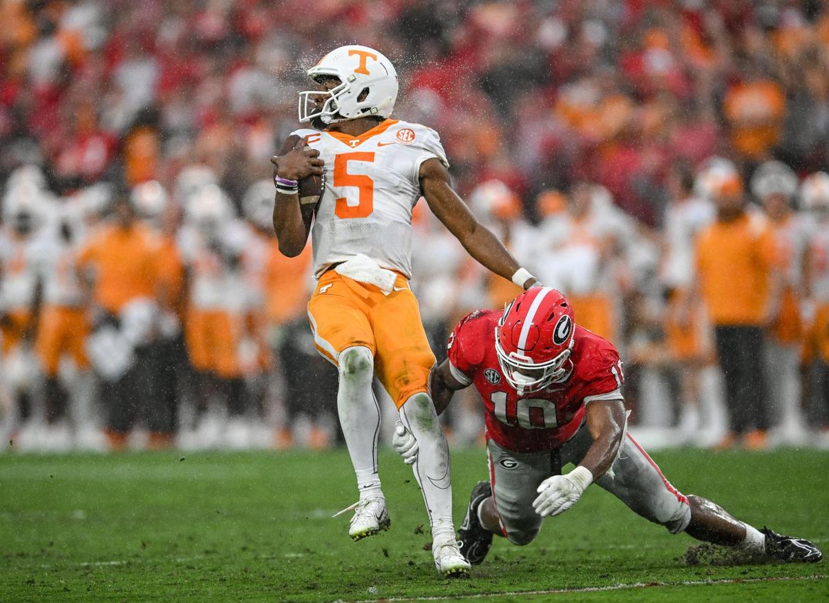 Tennessee quarterback Hendon Hooker get hauled down near the line of scrimmage by Georgia defender Jamon Dumus-Johnson Saturday in Athens.