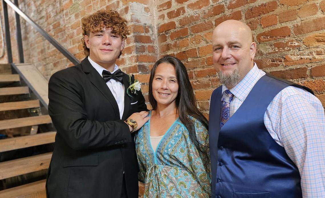 Clayton and Cindy Brown, right, with their son, Eli, are the new owners of The Apple Basket, a beloved gourmet caramel apple shop in Centerville. Eli Brown is helping out at the shop over the summer. This photo has been cropped.