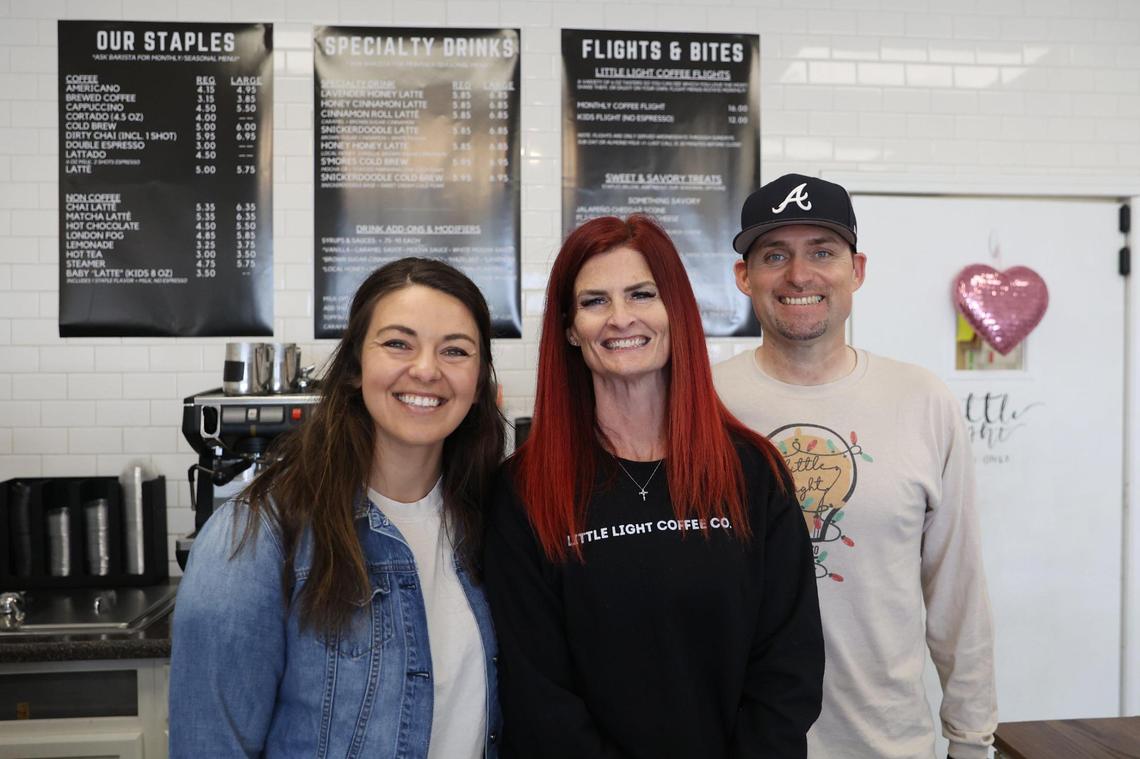 Little Light Coffee Co. original owner Sophia Smith (left) poses with new owners Jaimi (middle) and Kevin Norrell behind the counter at Little Light Coffee Co. in Warner Robins.