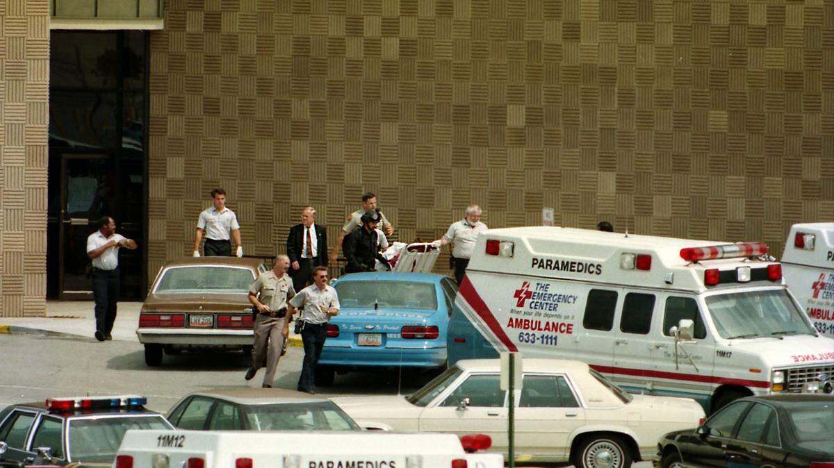 On the afternoon of July 1, 1993, paramedics and law enforcement authorities escorted a person on a stretcher from Macon Mall where Lafayette Rufus Hall held a woman hostage.