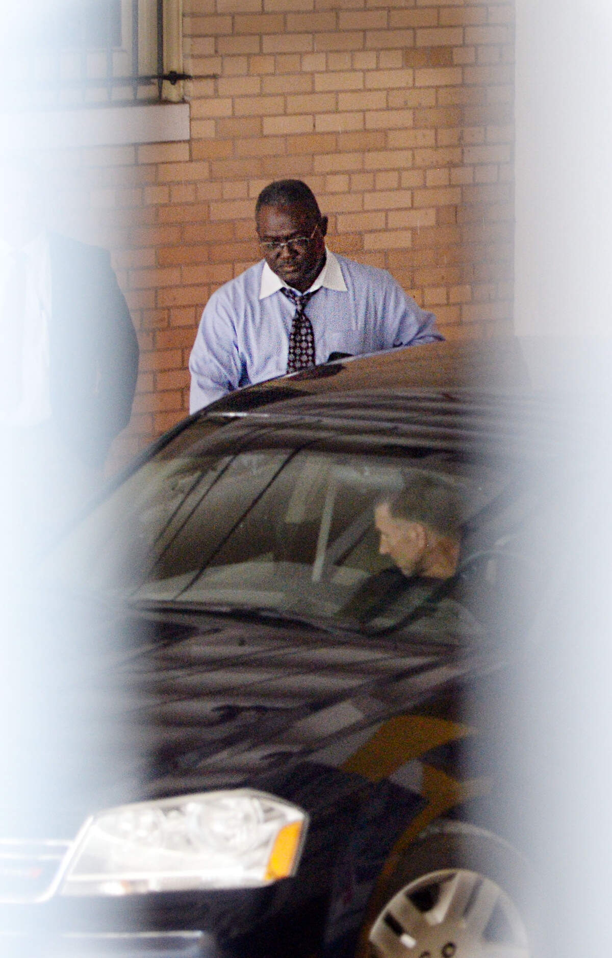 Former Bibb County School Superintendent Romain Dallemand, who has plead guilty to tax charges, exits through the secure entrance to the U.S. District Courthouse after finishing testimony Sept. 27 in the bribery and money laundering trial of Cliffard Whitby and Harold Knowles.