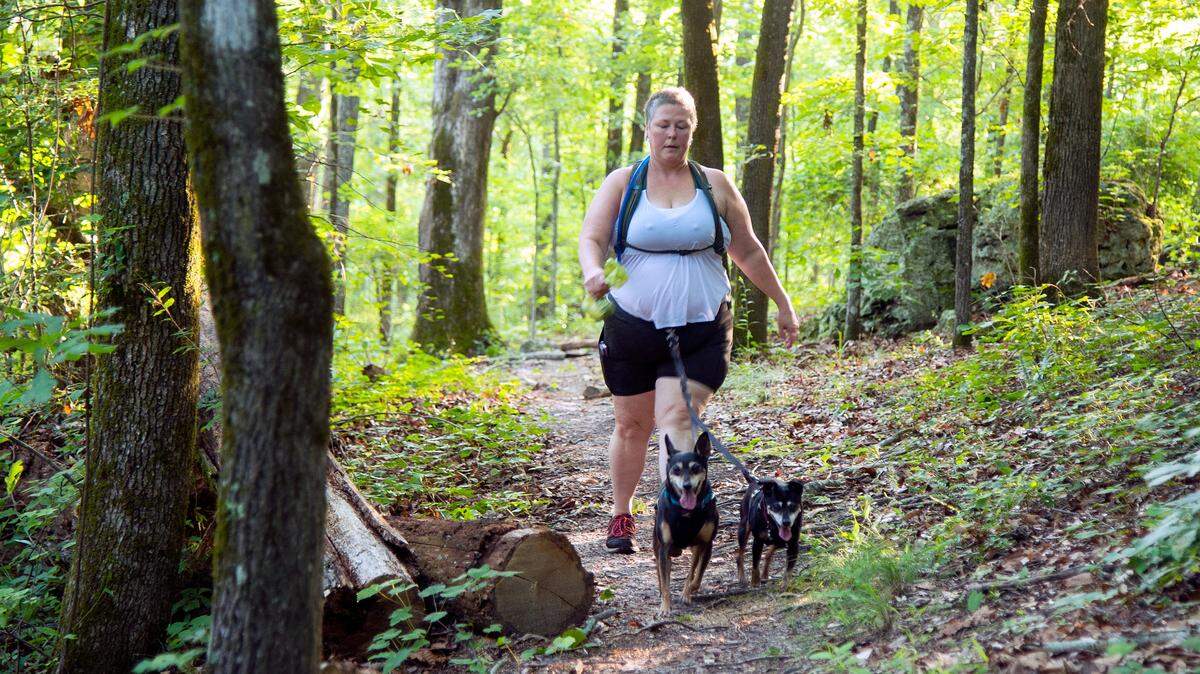 Pam Pinkston, fonder of Sothern Queer Folk Hikes, walks her two dogs at BrownÕs Mount June 10.